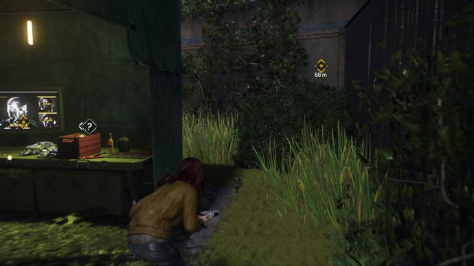 Mary Jane sneaks past a green tent filled with computer equipment in the Hunter's camp in the abandoned zoo.