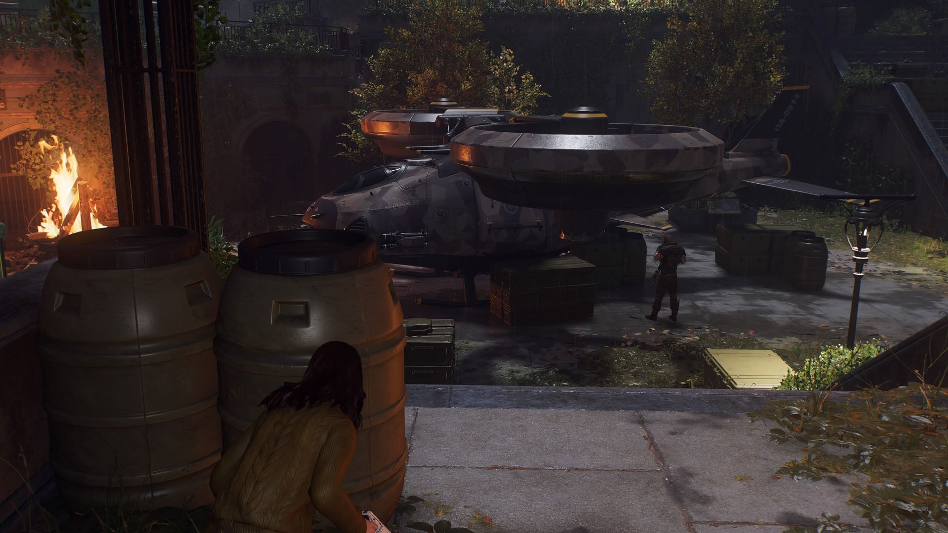 spider-man 2, MJ is crouching behind barrels on the left while looking at the hunter helicopter in the distance.