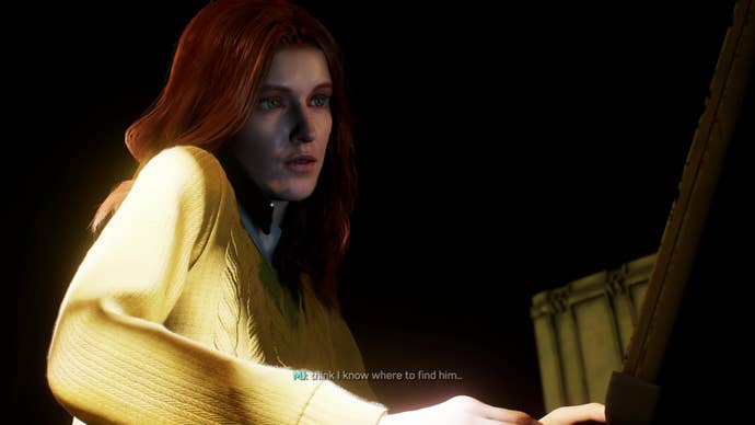 Mary Jane talks to Peter on her cell phone while working at her laptop in the back of a van.