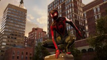 spider-man 2 miles morales crouching on a post in his black and red suit.