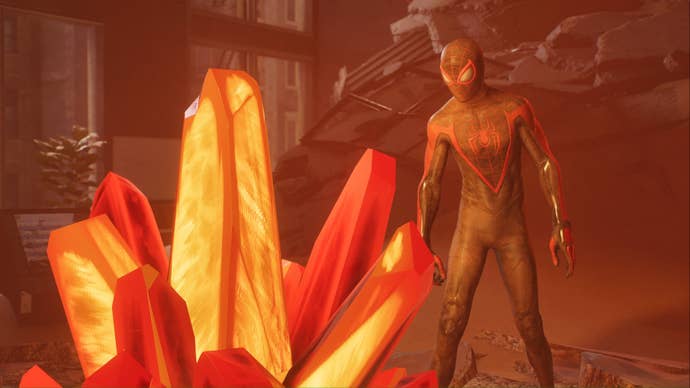 spider-man 2 miles morales looking at one of marko’s orange memory crystals