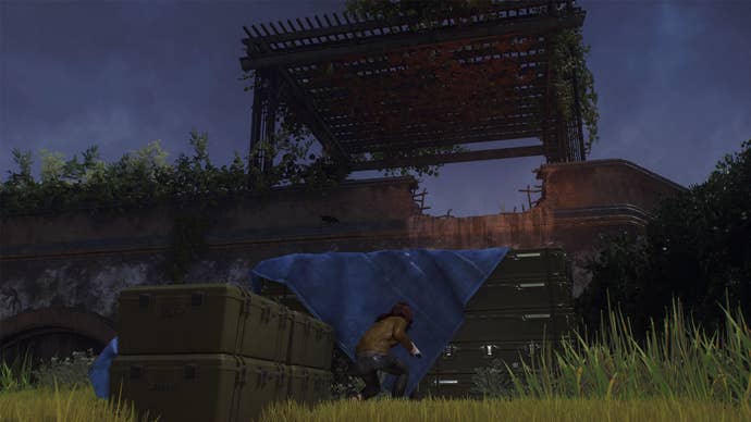 spider-man 2 mj is crouching by a large crate stack that leads up to a pergola on the next level.