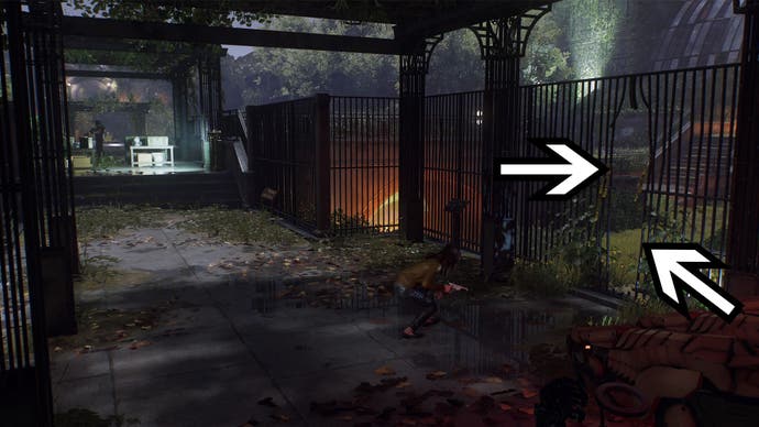 spider-man 2 mj crouching under pergola near gate opening, two arrows are pointing to the opening in the gate to the right of the screen.