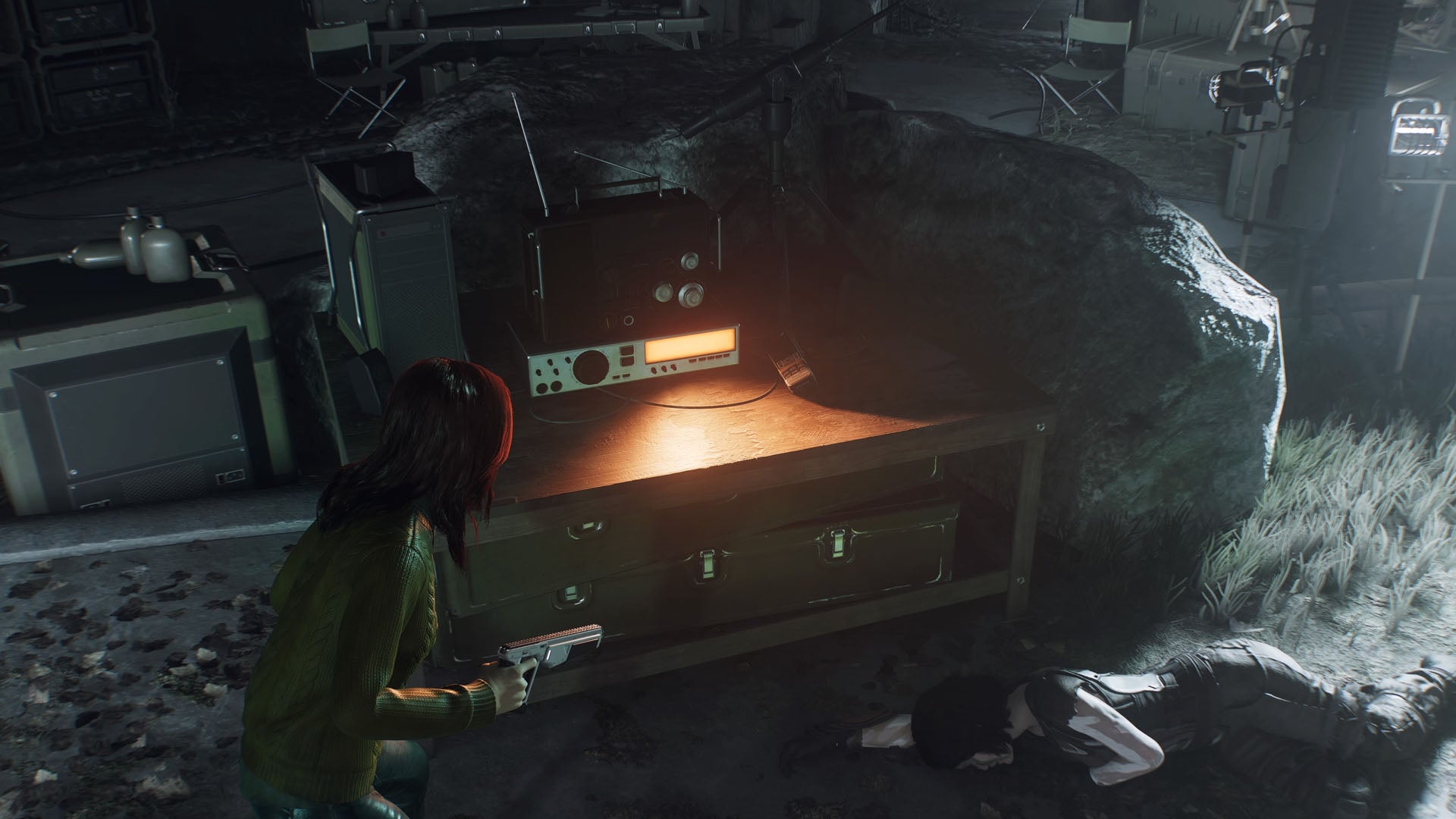 spider-man 2 mj is facing radio on table in a cave.