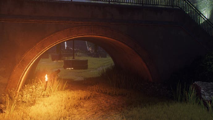 spider-man 2 mj  is crouched in tall grass near a flame lit torch underneath a large stone arch.