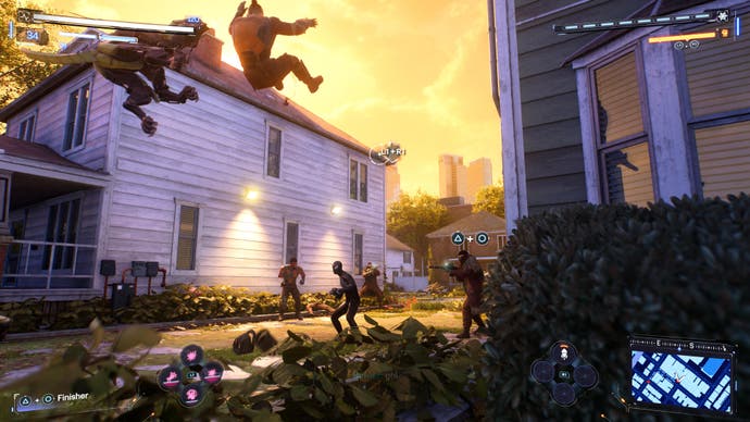 Marvel's Spider Man 2 screenshot showing Parker's Spider-Man smashing enemies away outside some houses in Queens