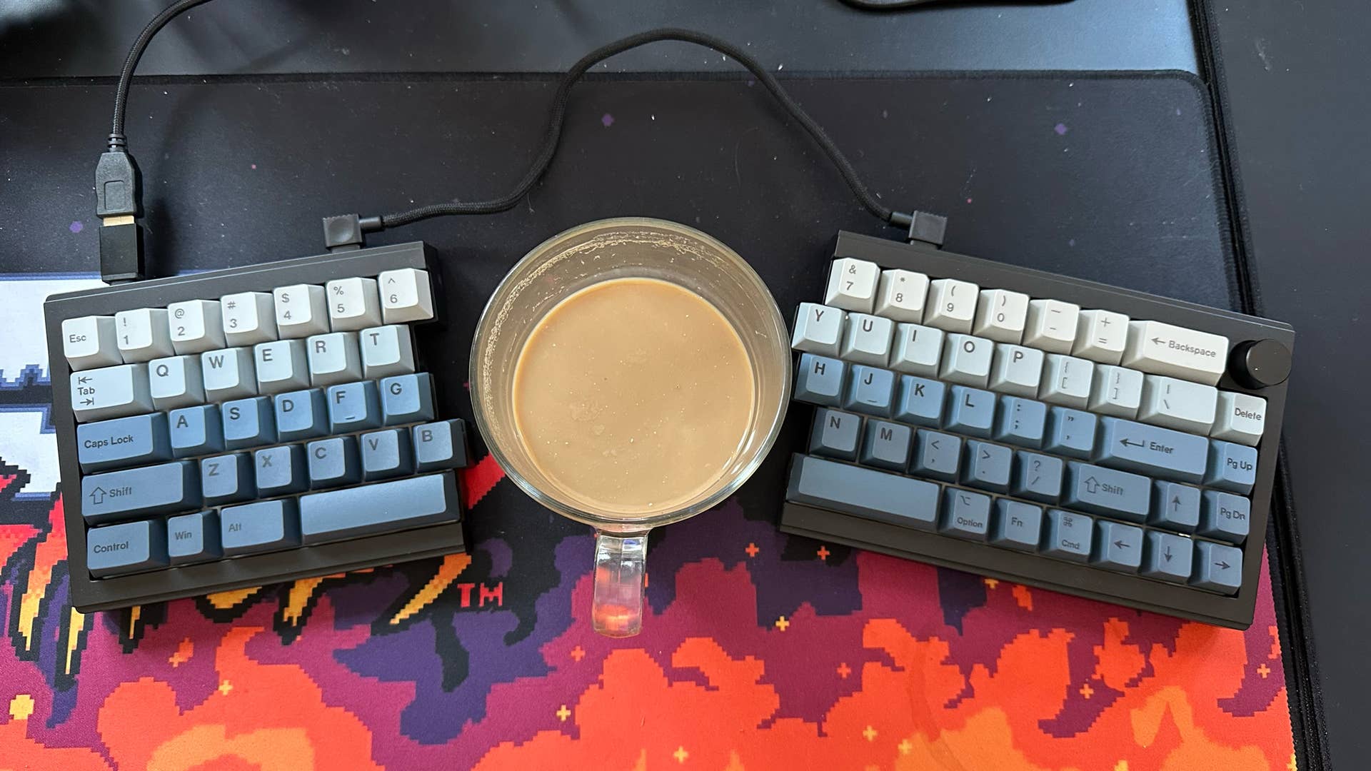 Epomaker Split 65 keyboard with a cup of coffee in the middle of the two halves of the split keyboard