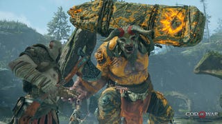 Kratos in God of War uses his Leviathan Axe to take on a large, horned advancing enemy
