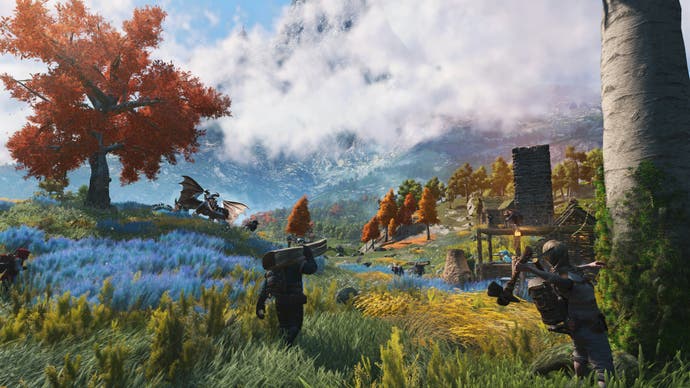 A screenshot from Light No Fire showing players building together in a lush forest valley beneath a towering, snowcapped mountain.