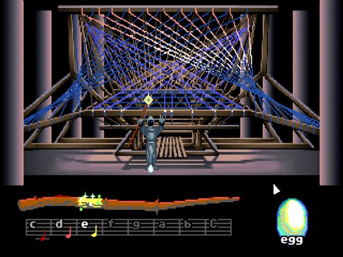 A hooded figure stands in front of a complex loom in Loom.