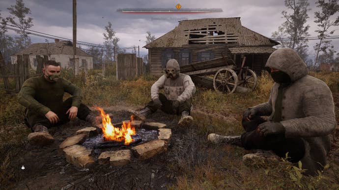 A trio of stalkers sit around a camp fire in the Zone.