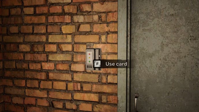 The player in Stalker 2 looks at a keycard machine beside a door in the workshop.