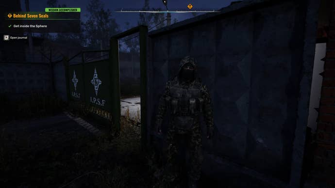 The player in Stalker 2 approaches the entrance to an IPSF outpost where a soldier is standing nearby.