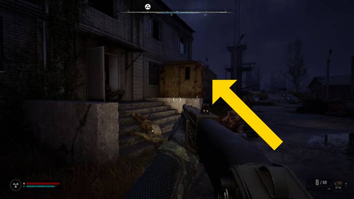The player in Stalker 2 stands outside a building at night.