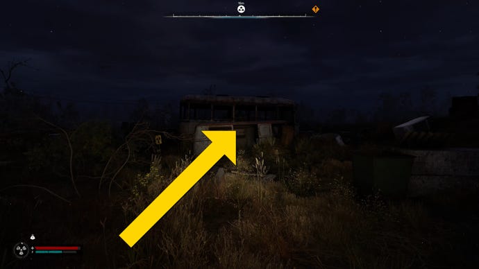 The player in Stalker 2 walks towards a broken down minibus at night.