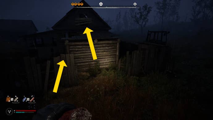 The player in Stalker 2 prepares to jump onto the top of a fence outside a building.