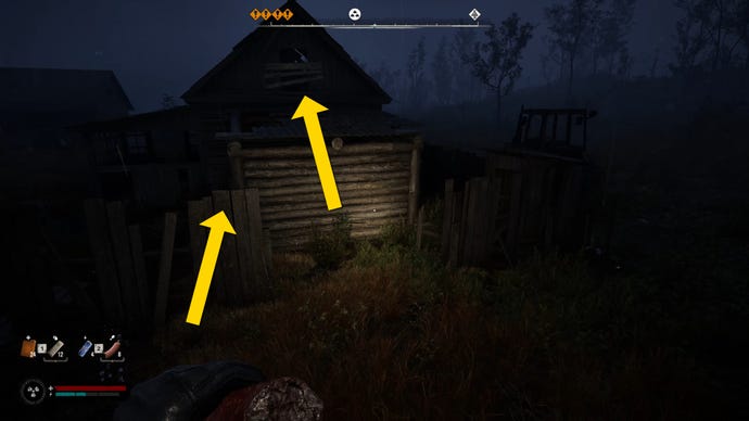 The player in Stalker 2 prepares to jump onto the top of a fence outside a building.