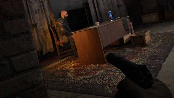 The player in Stalker 2 aims with a silenced pistol at Roosevelt, a character sitting down behind his desk.