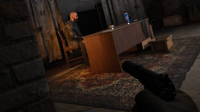 The player in Stalker 2 aims with a silenced pistol at Roosevelt, a character sitting down behind his desk.
