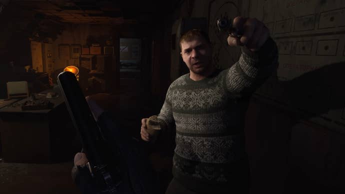 An NPC holds a gun to the player’s head in a house in Stalker 2: Heart Of Chornobyl.