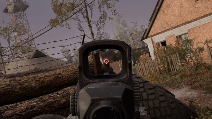 The player in Stalker 2 aims at an enemy using a holographic scope atop their Shotgun.