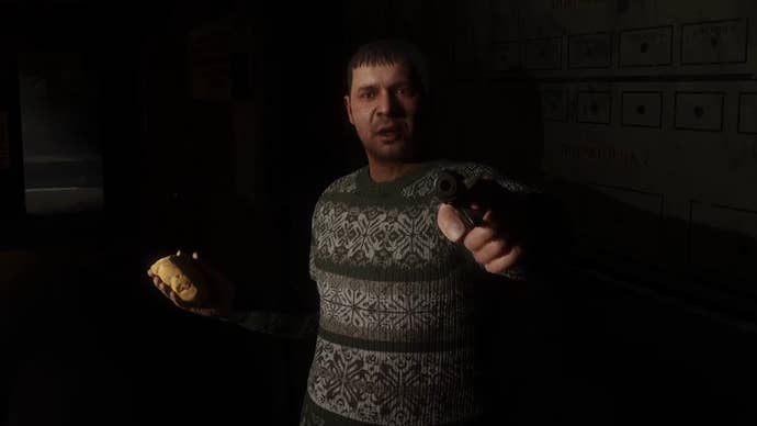 Solder, a character in Stalker 2, points a gun at the player in a darkened room.