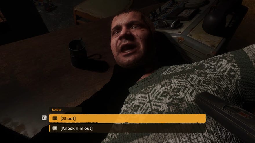 The player in Stalker 2 holds down the character Solder by the throat and aims at him with a pistol.