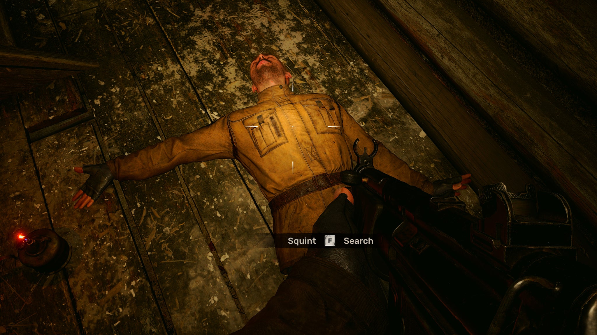 The player in Stalker 2 looks down at the dead body of Squint lying on a wooden floor. - 6