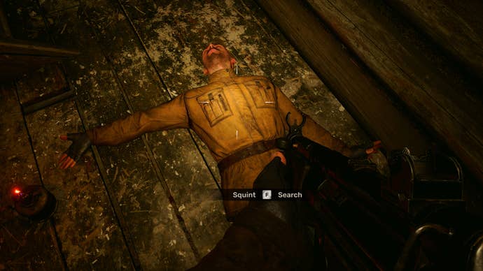 The player in Stalker 2 looks down at the dead body of Squint lying on a wooden floor.