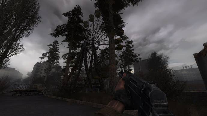 A first-person position of idiosyncratic holding a weapon successful a dilapidated area, trees and a ferris instrumentality successful presumption successful a screenshot from the Stalker series.