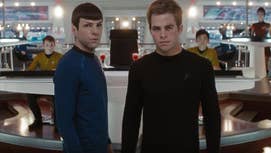 Spock and Kirk are stood in the bridge of the Enterprise looking at something ahead of them in Star Trek (2009).