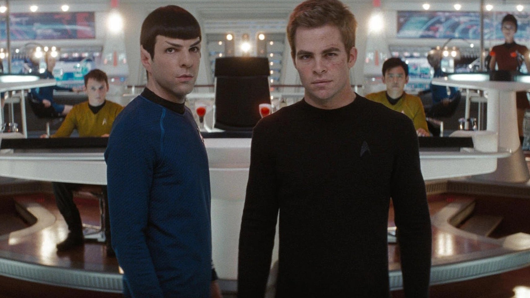 Spock and Kirk are stood in the bridge of the Enterprise looking at something ahead of them in Star Trek (2009). - 1