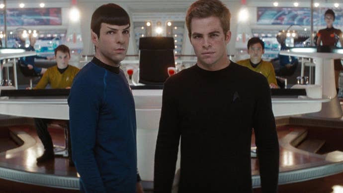 Spock and Kirk are stood in the bridge of the Enterprise looking at something ahead of them in Star Trek (2009).