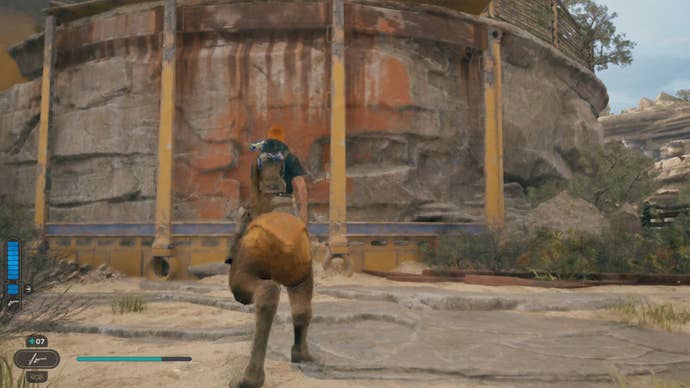 Cal sits on a Nekko in front of a ledge, at the top of which is another Star Wars Jedi: Survivor perk slot essence.