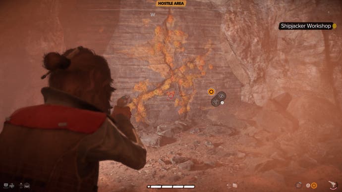 Star Wars Outlaws Kay targets a cracked wall in the ship pirate's workshop