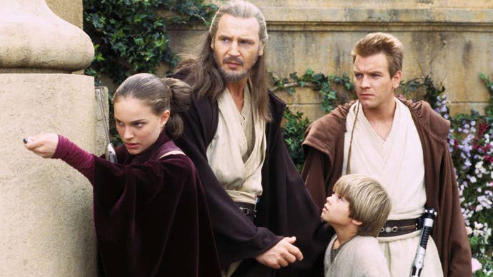 A still from Star Wars: The Phantom Menace showing Padme, Qui Gon-Jinn, Obi Wan Kenobi, and a young Anakin peering out from behind a corner.