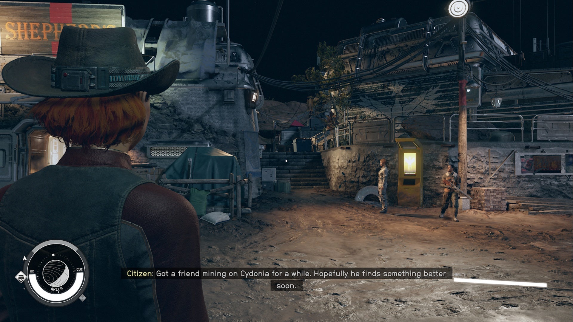 starfield akila city, player in cowboy hat is facing a small pathway between shepherd&rsquo;s store on the left and the freestar collective kiosk on the right.