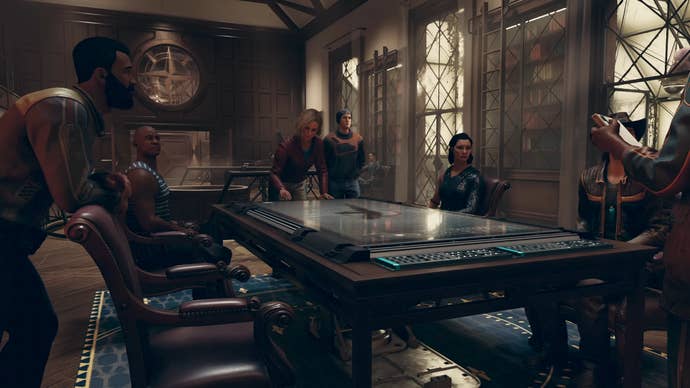 A group of Constellation members sit around a table and talk in Starfield.