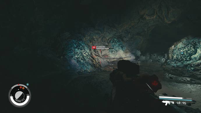 A Starborn appears in front of artifact Theta in Starfield.