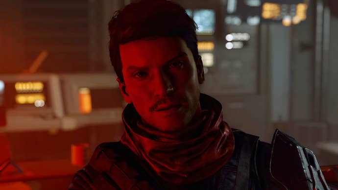 A human NPC in Starfield looks into the camera, bathed in red light.