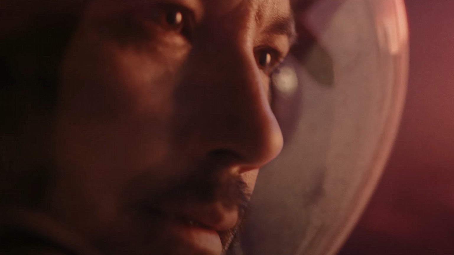 A moonman looks to the right in Starfield&rsquo;s live action trailer.