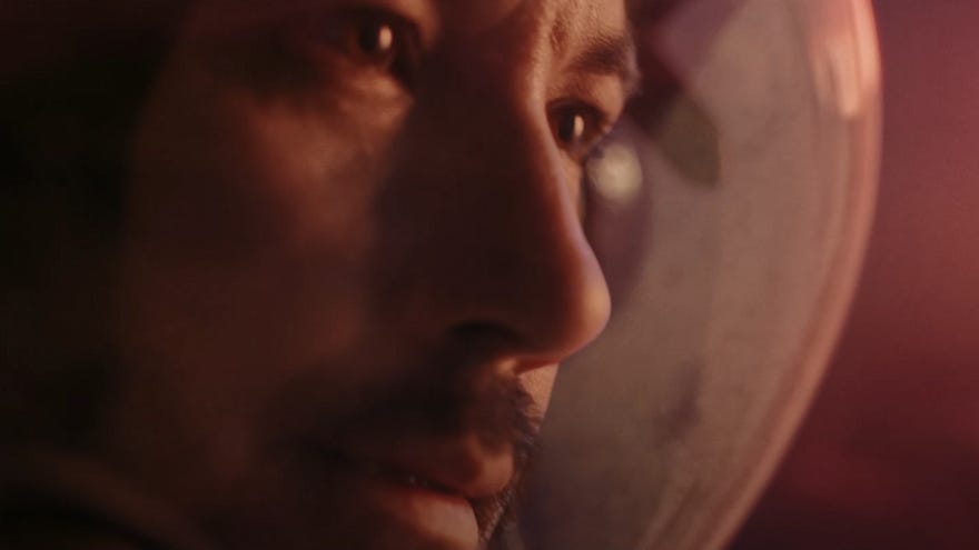 A moonman looks to the right in Starfield's live action trailer.