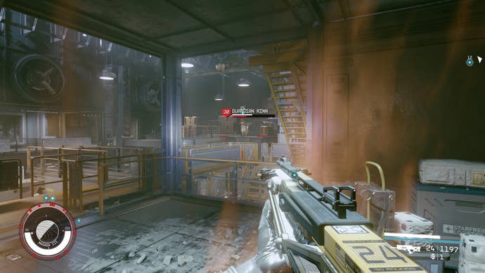 Guardian Rinn engages in combat with the player in a large room in Starfield.