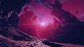 A person in a spacesuit stands amid unusual arcing rock formations lit by an eerie red light.