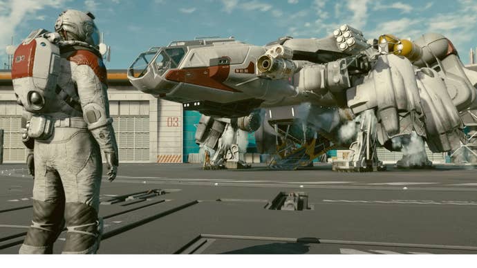 An astronaut looks at their Starfield ship.