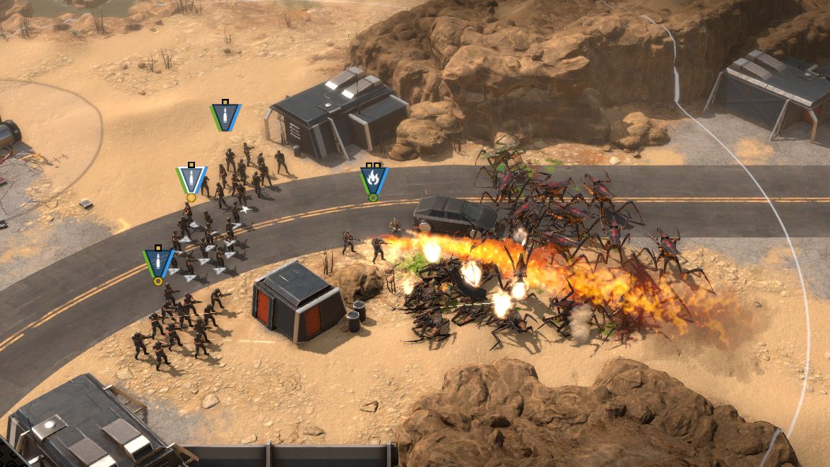 3 squads of human rifles (plus a team of combat engineers with flamethrowers) attack a horde of oncoming bug aliens in the demo for Starship Troopers - Terrann Command
