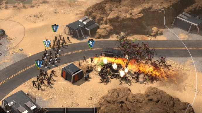 3 squads of human rifles (plus a team of combat engineers with flamethrowers) attack a horde of oncoming bug aliens in the demo for Starship Troopers - Terrann Command