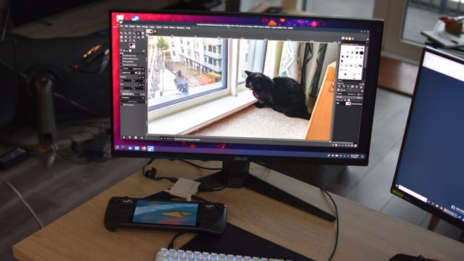 The Steam Deck in desktop mode, running GIMP on a monitor with a mouse and keyboard attached via USB hub.