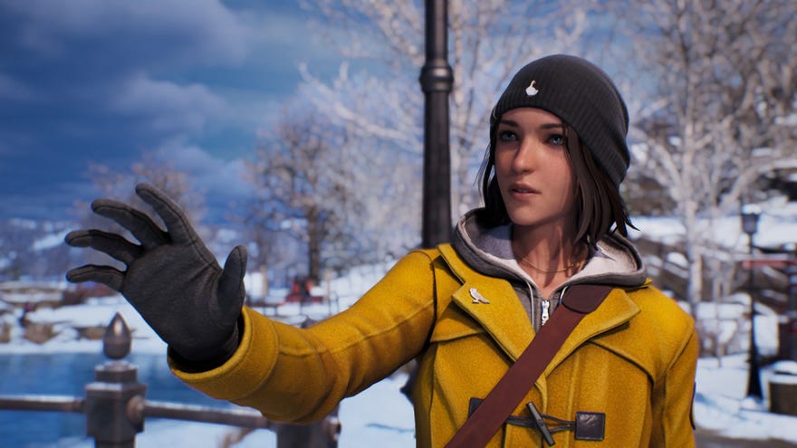 Max reaches out her hand, wearing a yellow winter jacket.
