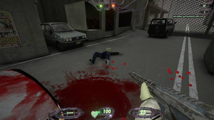 The player aims their gun at an enemy they’ve just finished, a pool of blood lies at their feet.